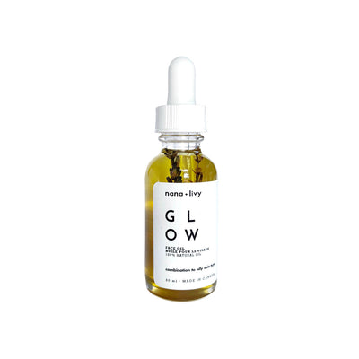 Bottle of 'GLOW' face oil with dropper labeled 'nana + livy' on a white background