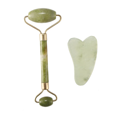 Jade facial roller and gua sha tool on a white background