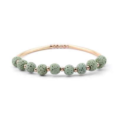 Bracelet with green beads and rose gold accents on a white background