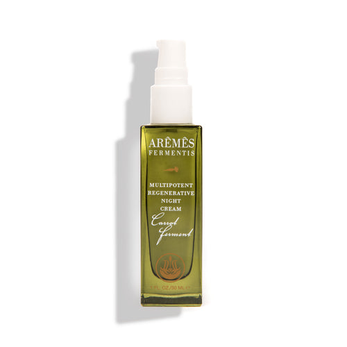 Green skincare bottle with white pump on a white background