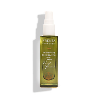 Green skincare bottle with white pump on a white background